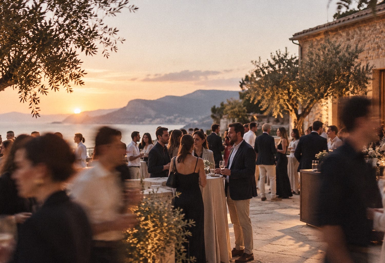 Corporate event at sunset on a sea-view terrace in Mallorca, with guests mingling